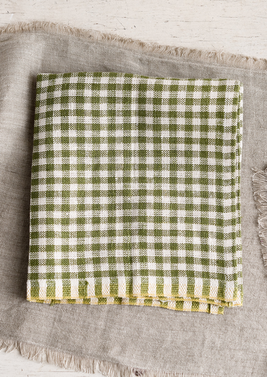 A  linen dinner napkin in olive gingham.