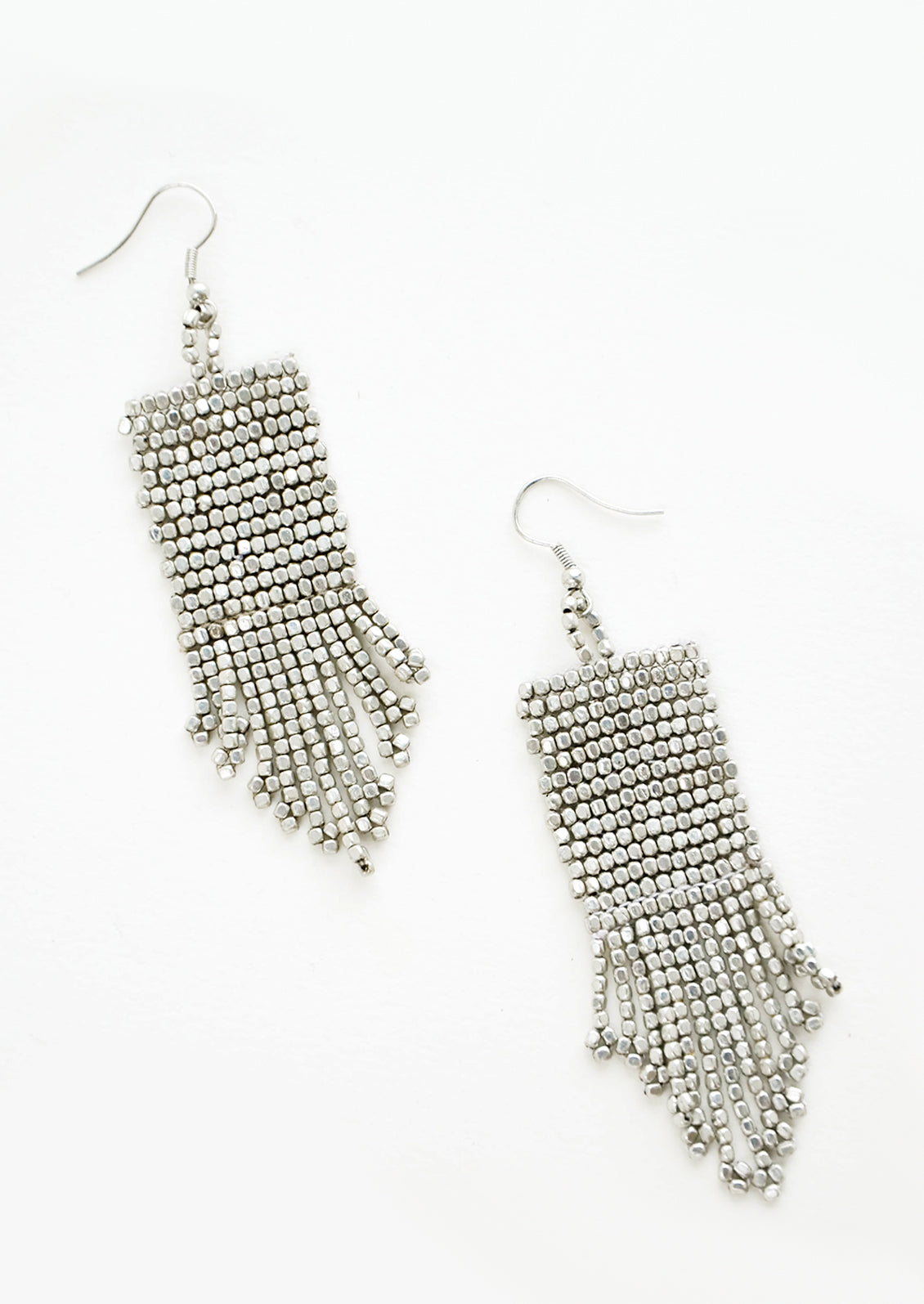 Silver rectangular taper fringe beaded earrings.