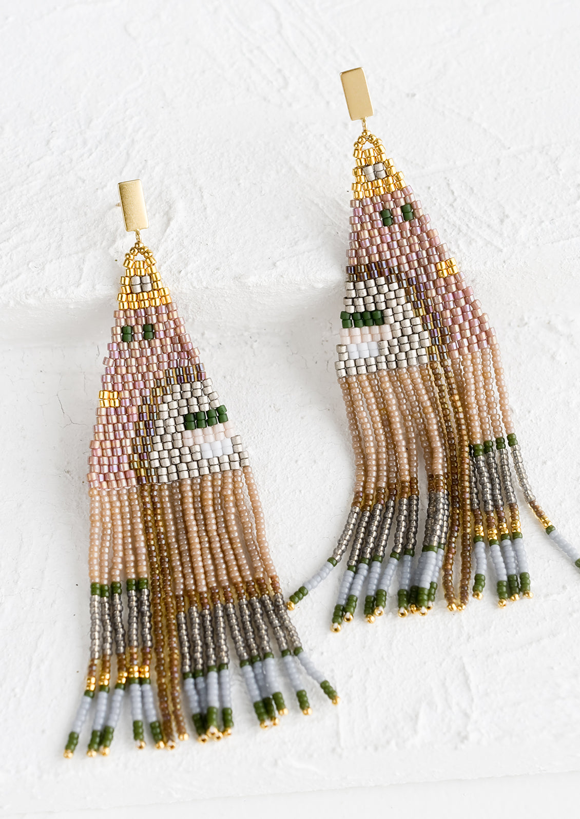 A pair of beaded earrings in mauve and green geometric design with brass posts.