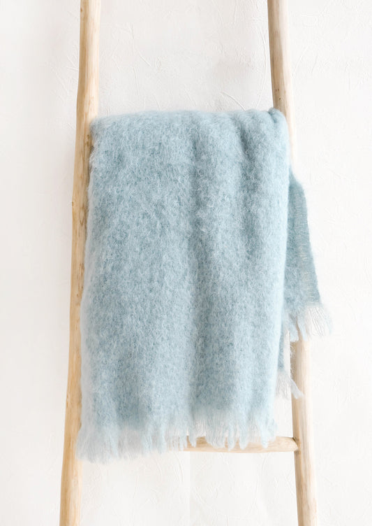 Fluffy mohair blanket with soft fringe trim in serene shade of blue