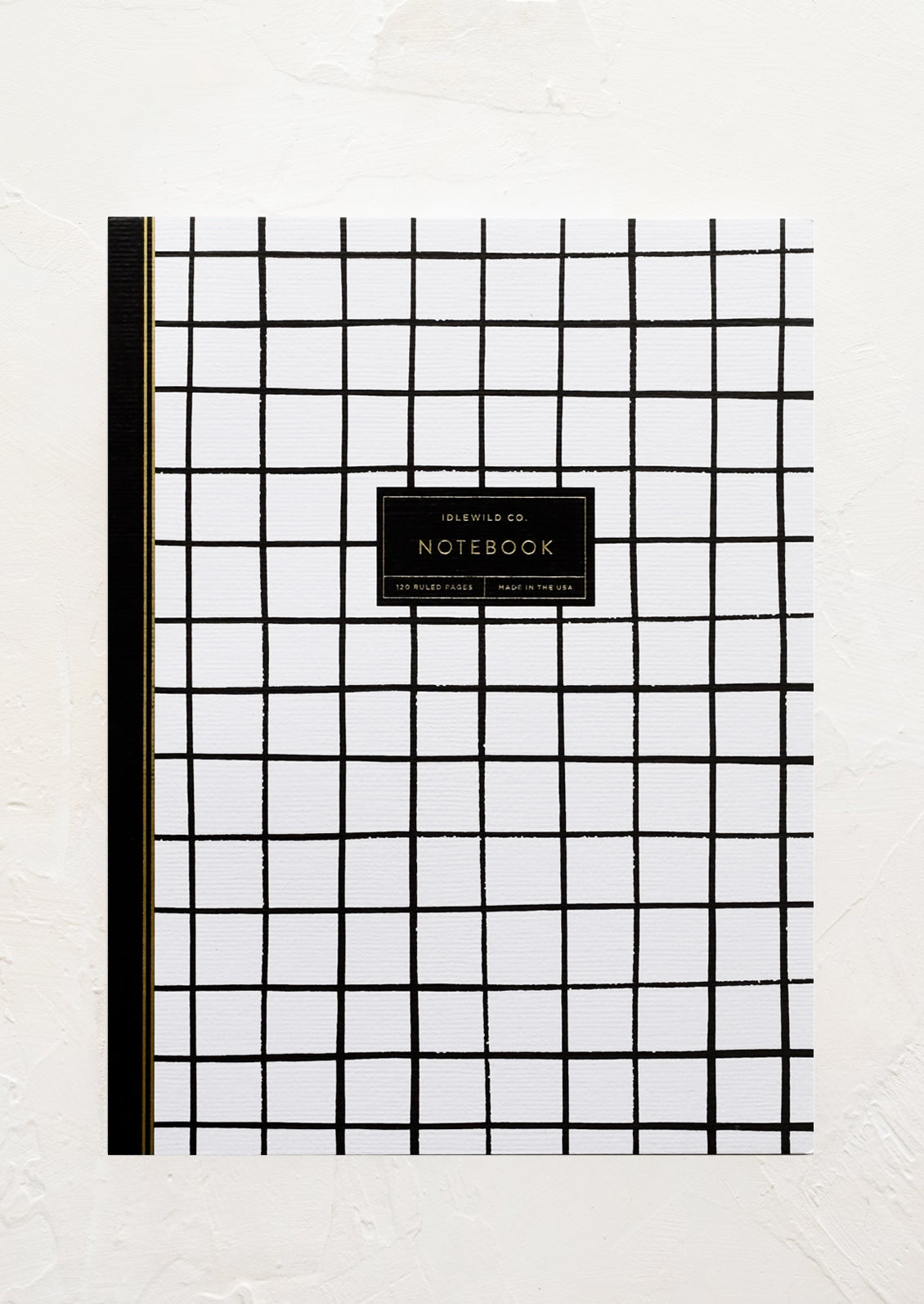 A black and white windowpane printed notebook.