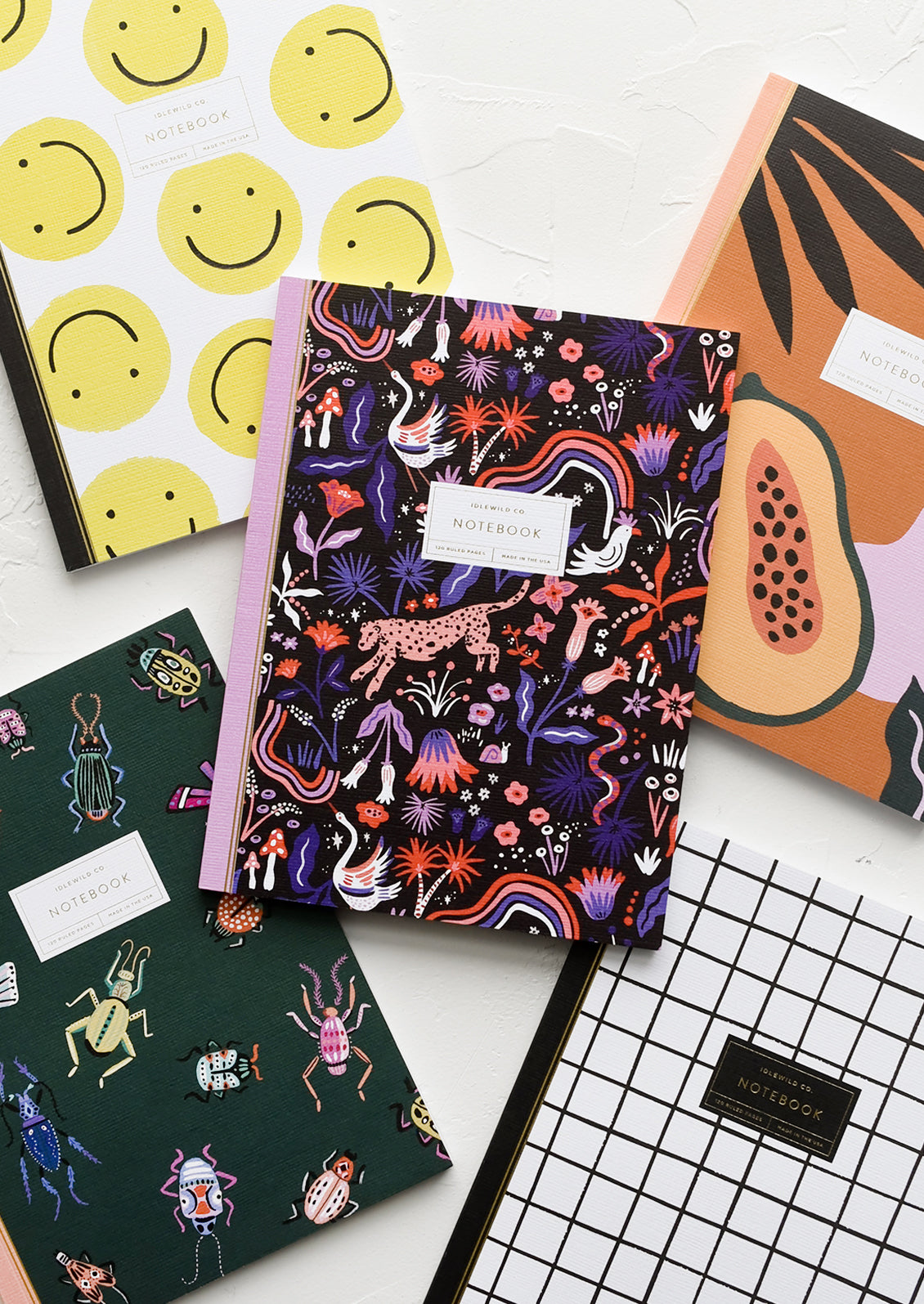 An assortment of novelty printed notebooks.