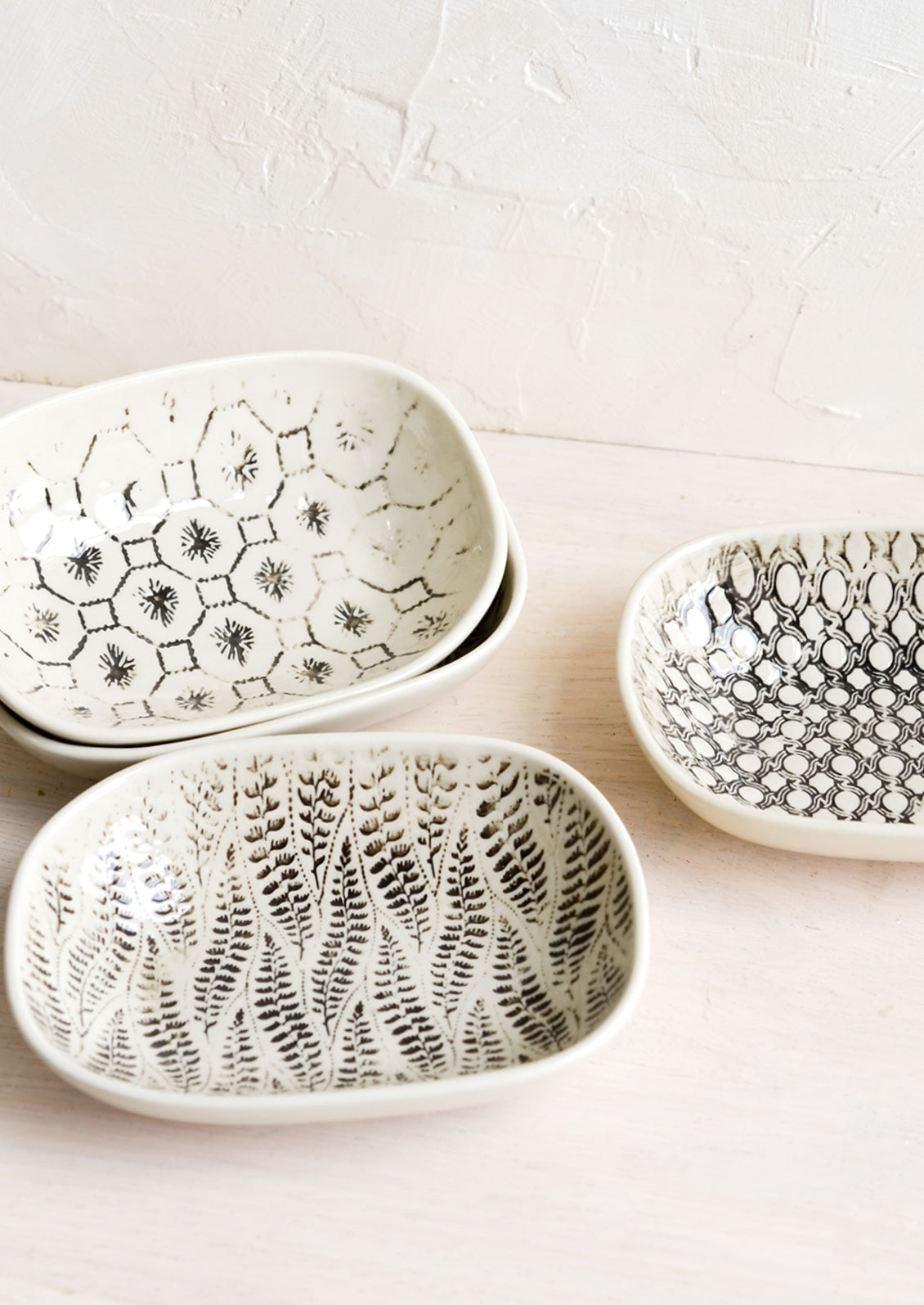 Small oval ceramic dishes in assorted black and white patterns.