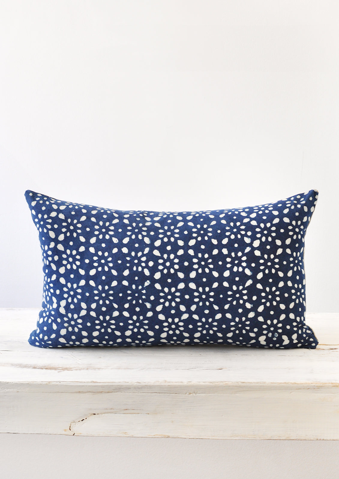 A 12x20 indigo and white block printed pillow.