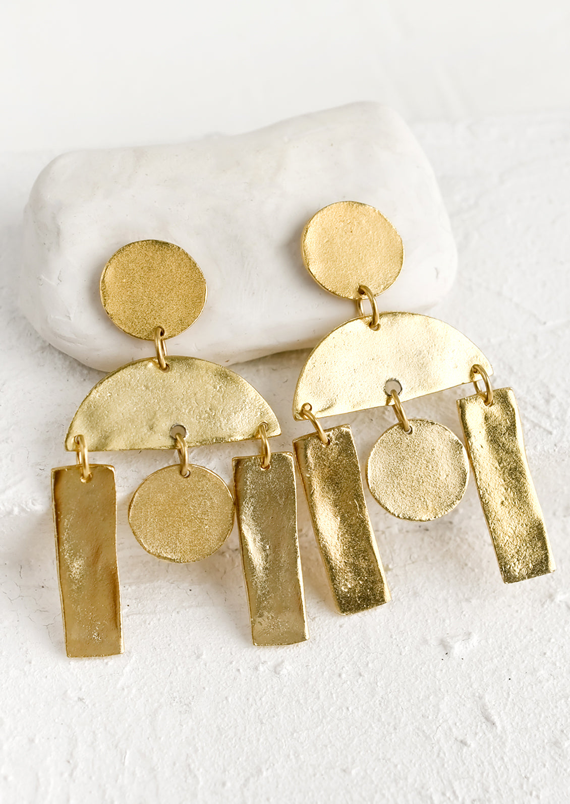 A pair of gold earrings with geometric chandelier design.