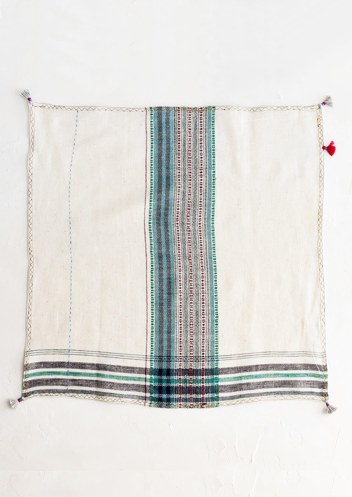 A khadi cotton napkin with tassel detailing.