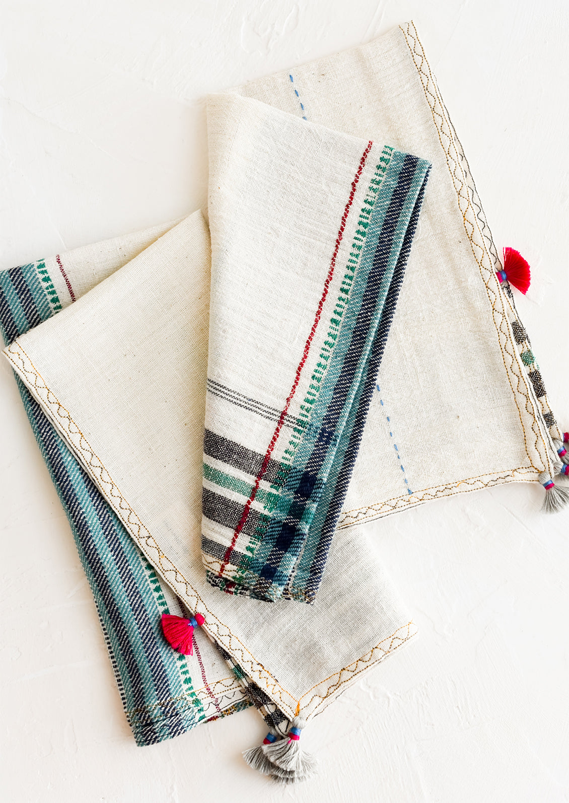 A pair of khadi cotton napkins with tassel detailing.