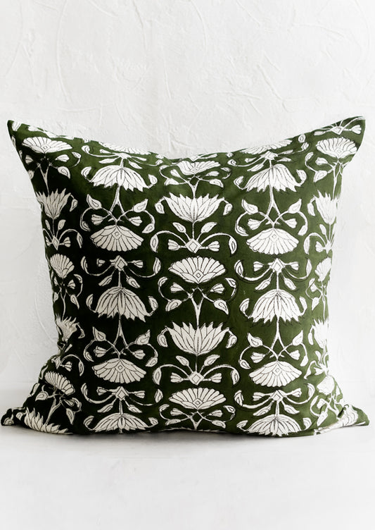 A block printed pillow in green and ivory floral motif.