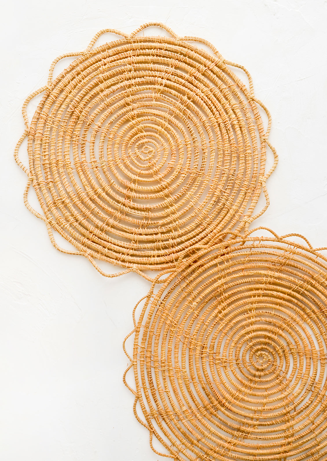 A round placemat set with open weave scalloped edge.