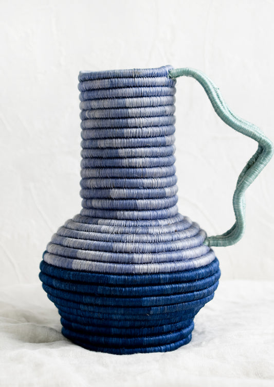 A sculptural sweetgrass vase with wavy handle in blue multi.