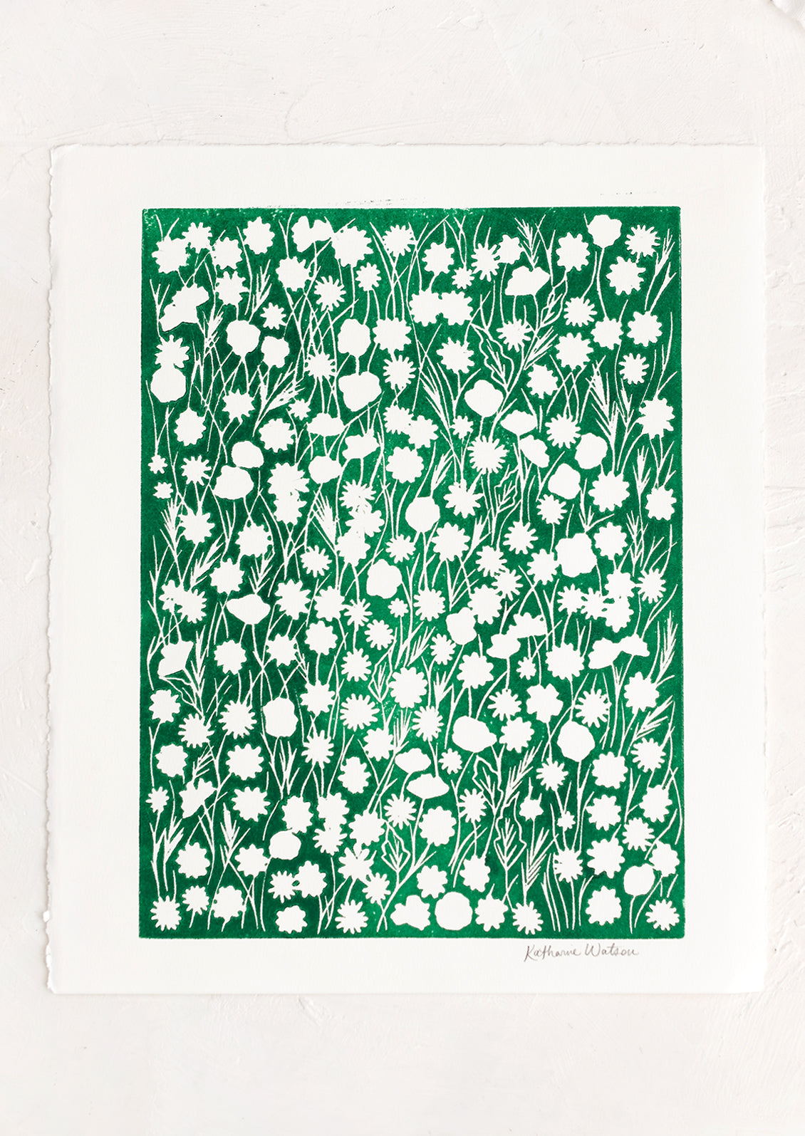 A block printed art print on deckled edge paper with green box with white flowers.