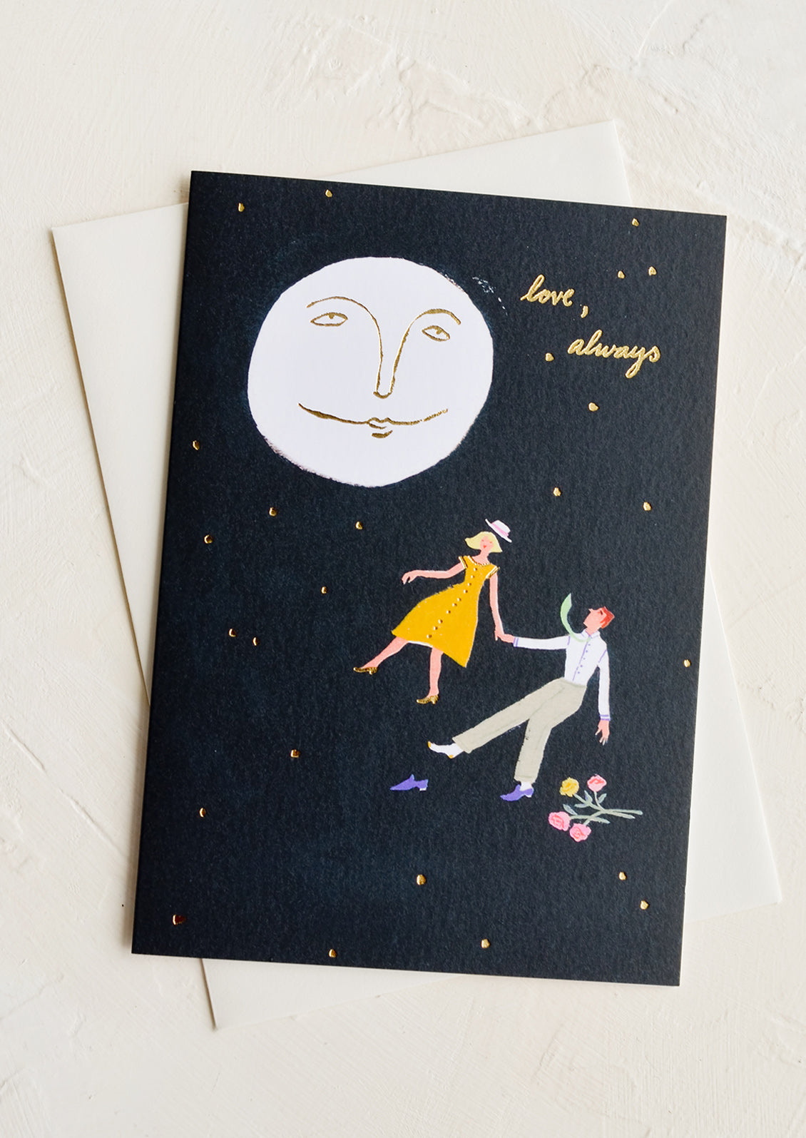 A greeting card with image of couple and moon, text reads "love, always".