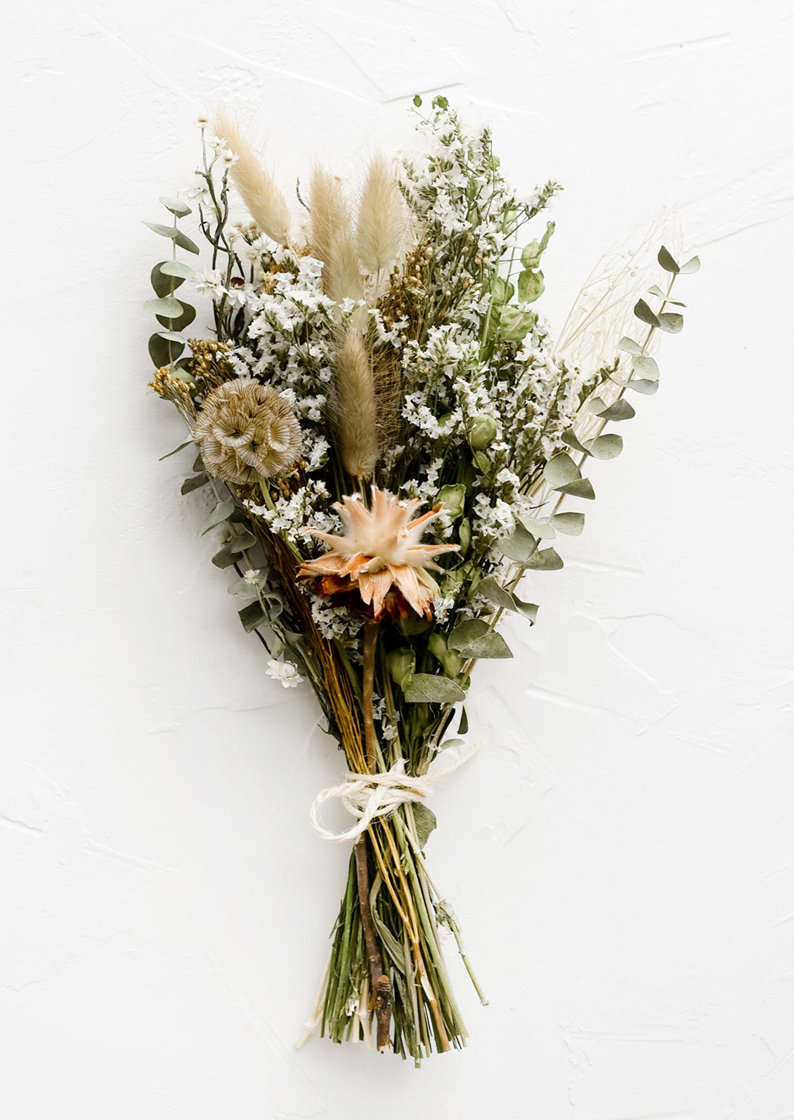 A bouquet of dried flowers in neutral mix.