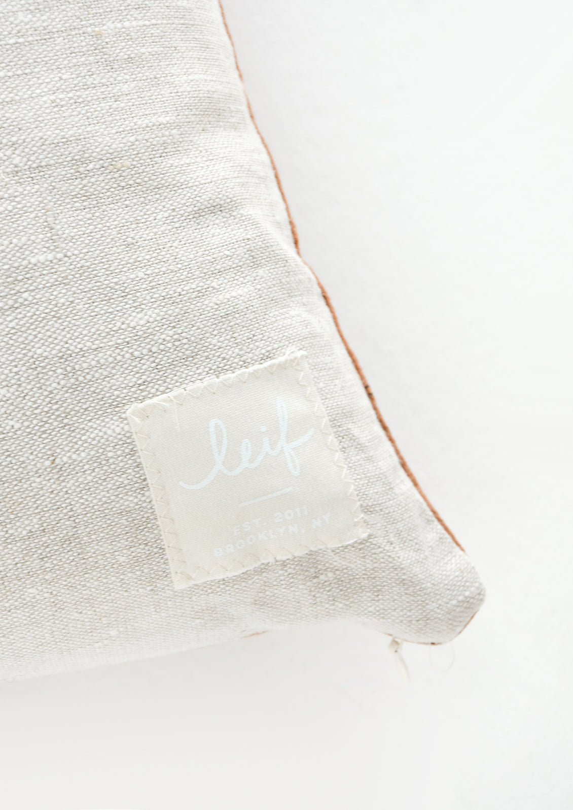 Logo patch on linen pillow back