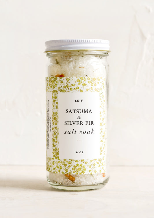 A straight sided glass jar containing Satsuma & Silver Fir salt soak.