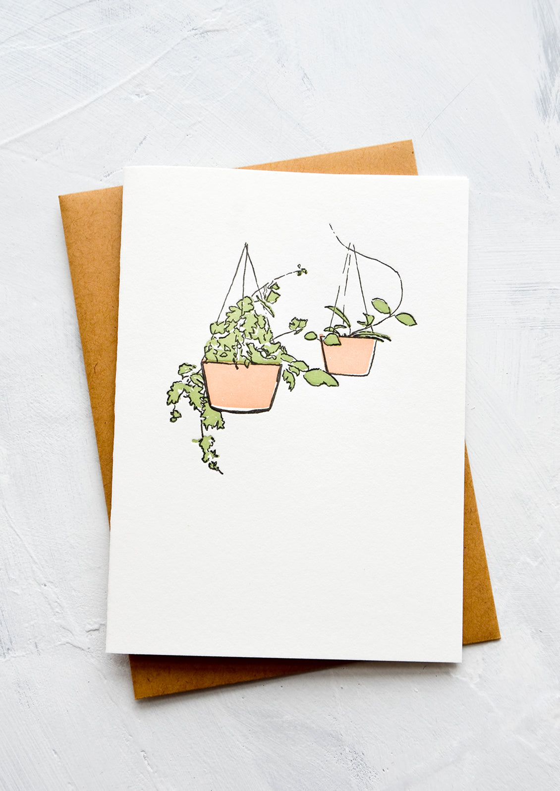 A letterpress printed greeting card with an image of two hanging pots with plants