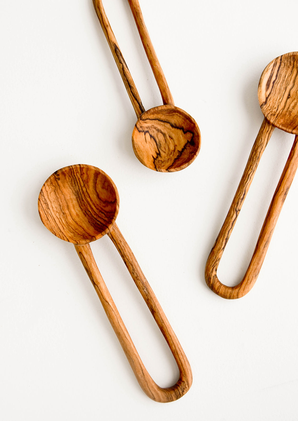 Wooden spoons in decorative grained olivewood, with hollow loop-shaped handles