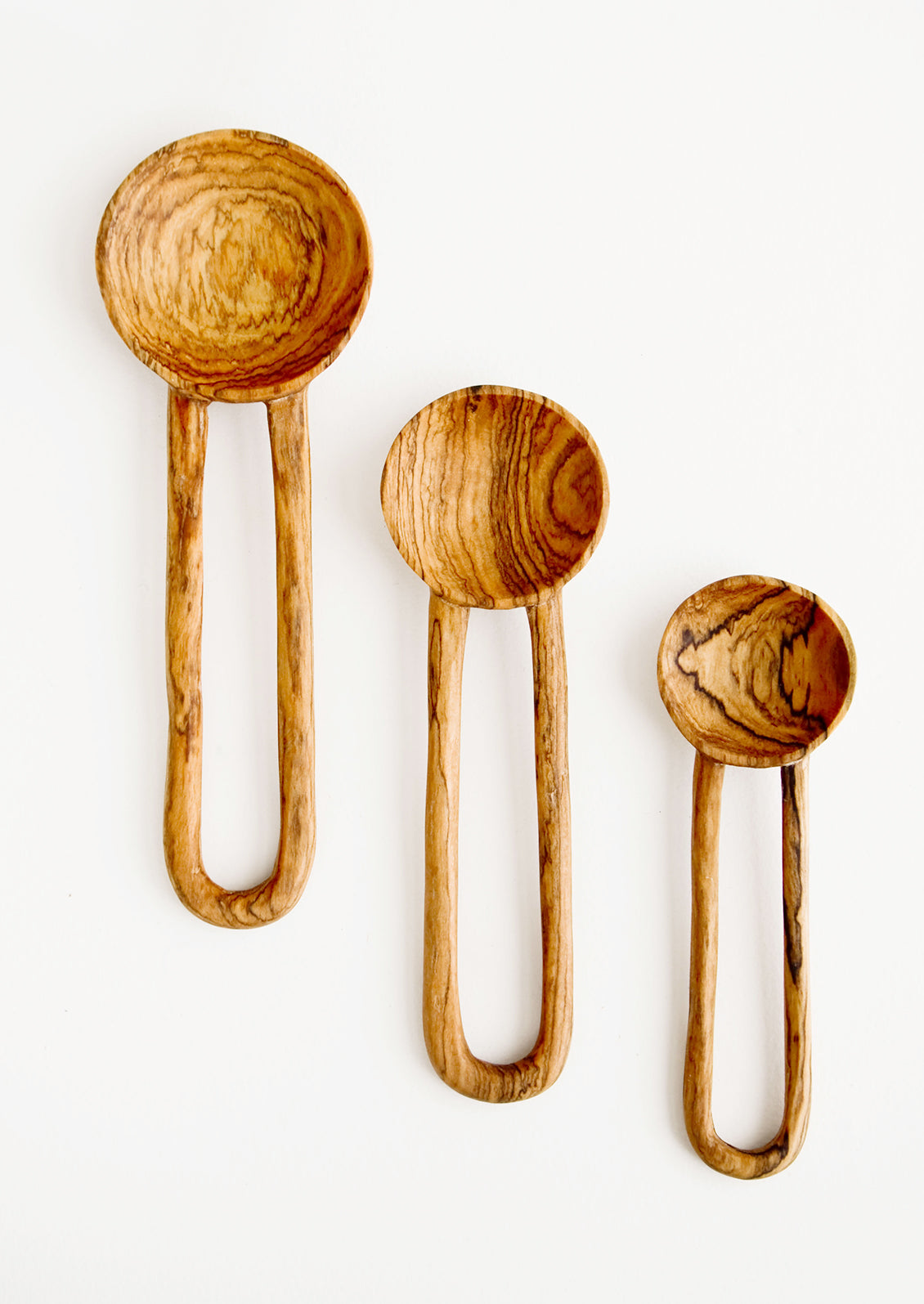 Wooden spoons in decorative grained olivewood, with hollow loop-shaped handles in three incremental sizes