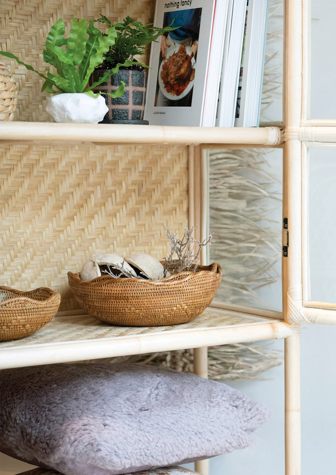 A brown woven shallow rattan basket with wavy edge.