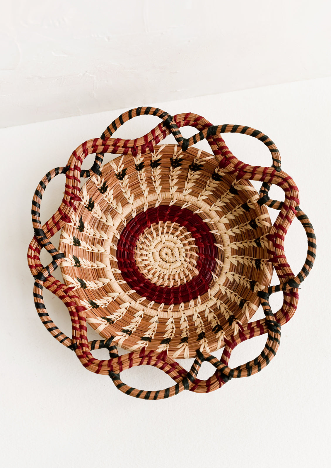 A woven basket with swirling, intertwined silhouette.