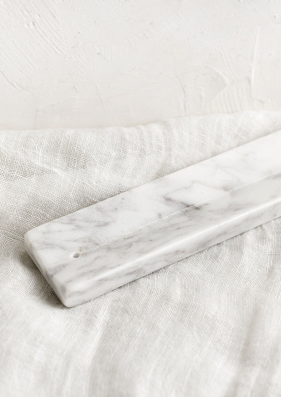 A long solid marble incense burner tray.