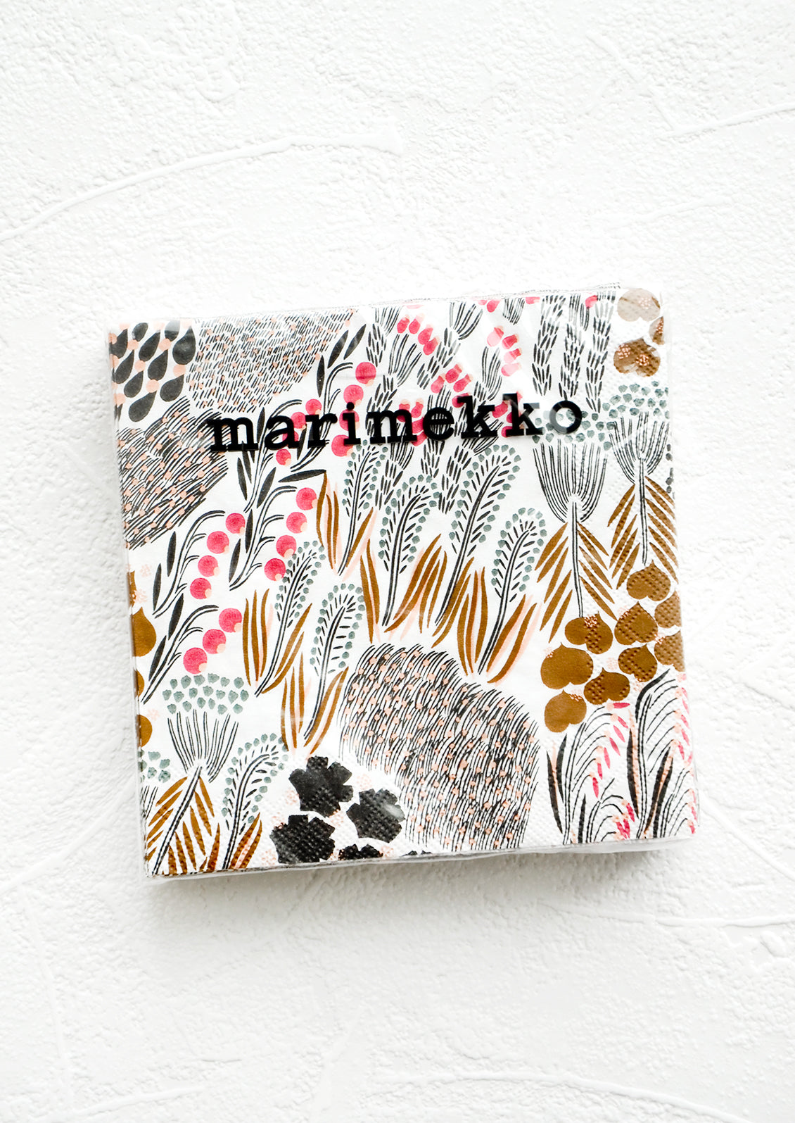 Packaged disposable paper napkins in square cocktail size with brown and pink floral print.