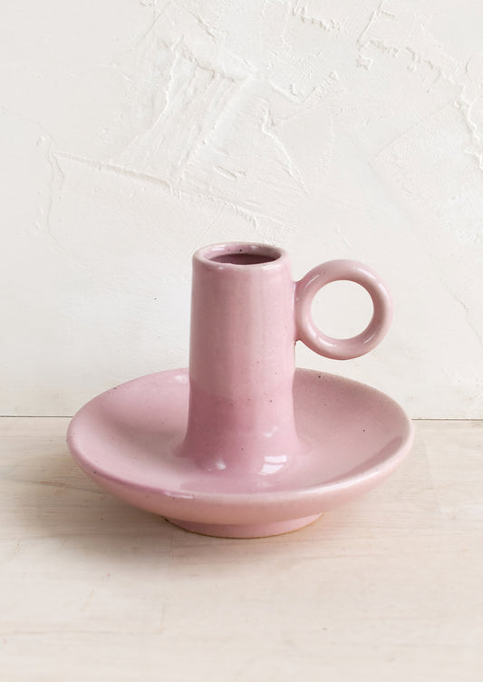 A pink ceramic taper candle holder.