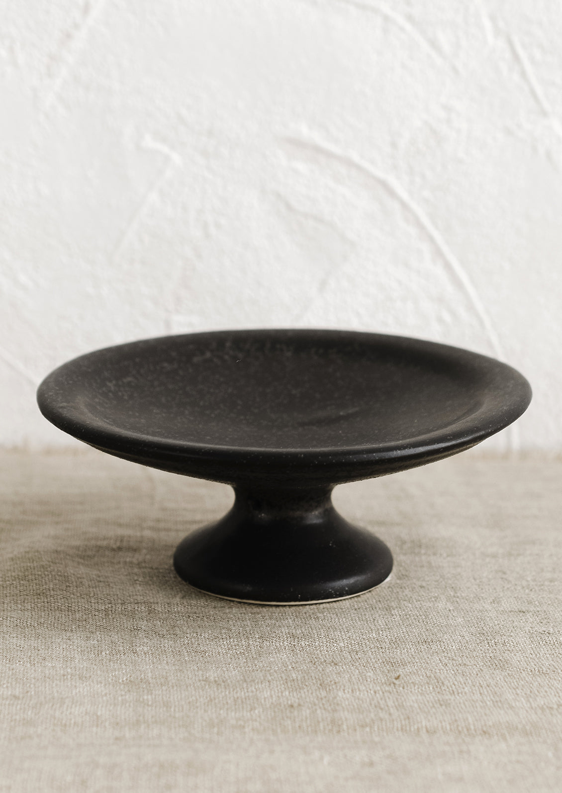 A black ceramic pedestal riser.