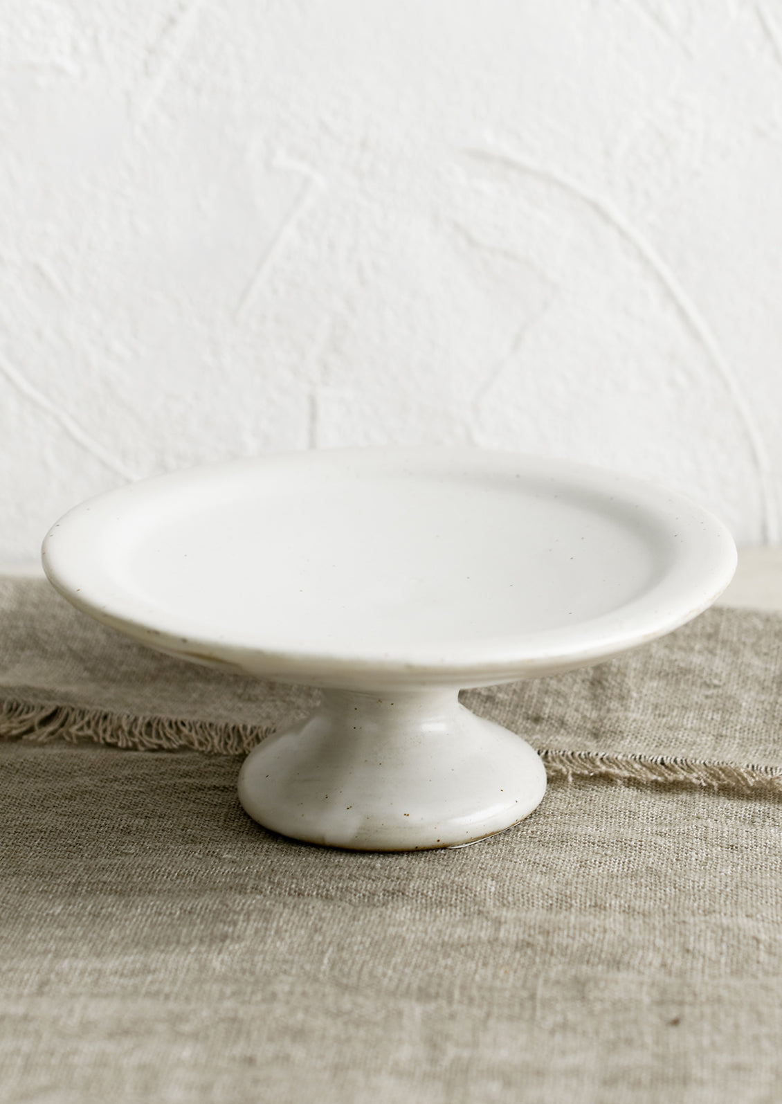 A white ceramic pedestal riser.