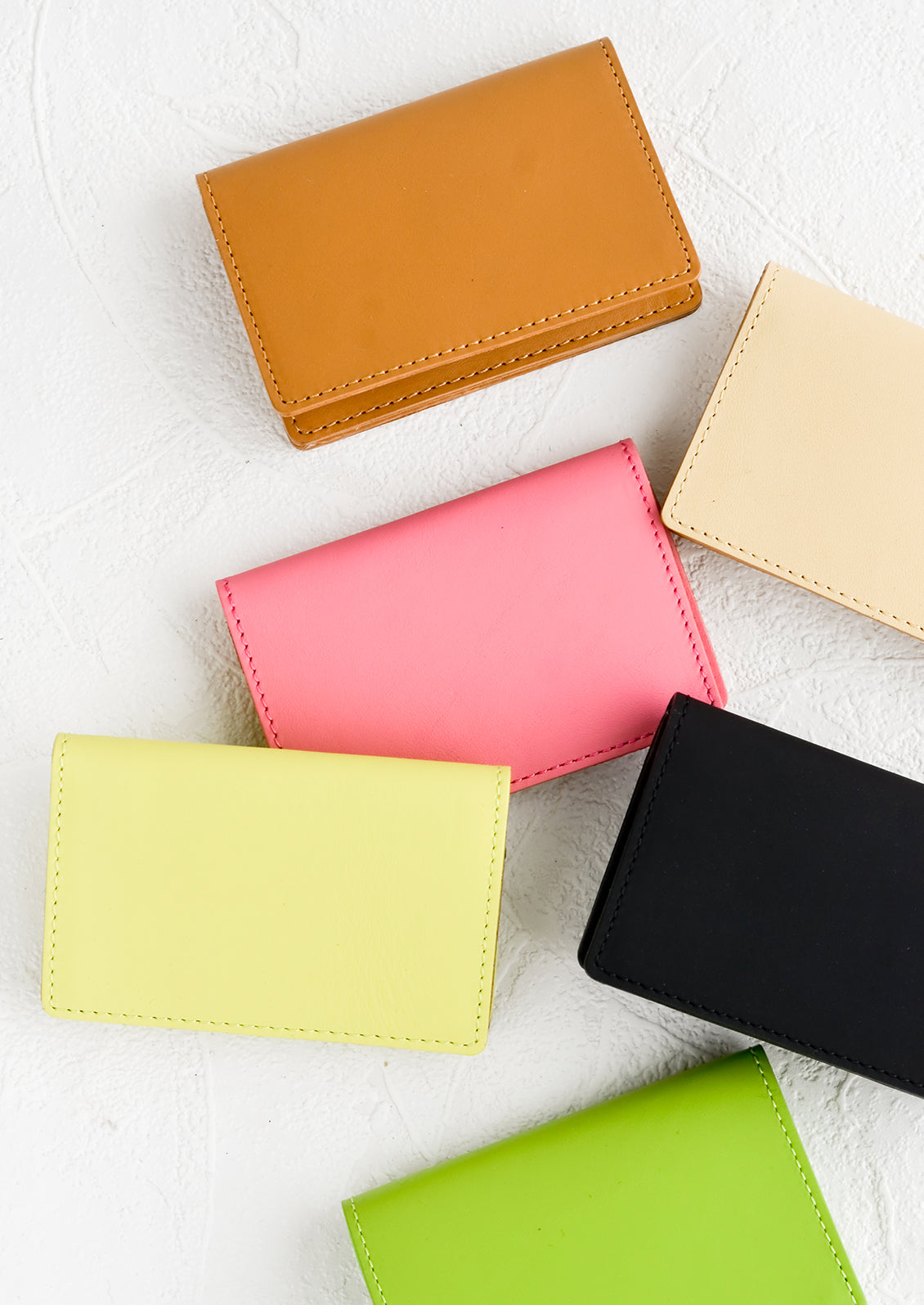 Leather card holder wallets in assorted colors.