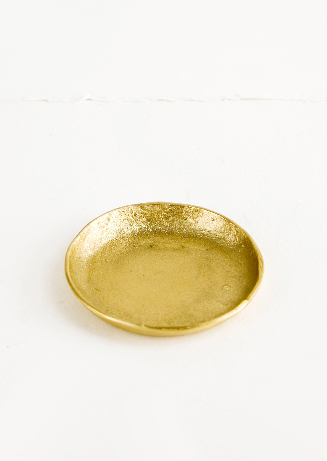 Small brass plate with organic, natural texture