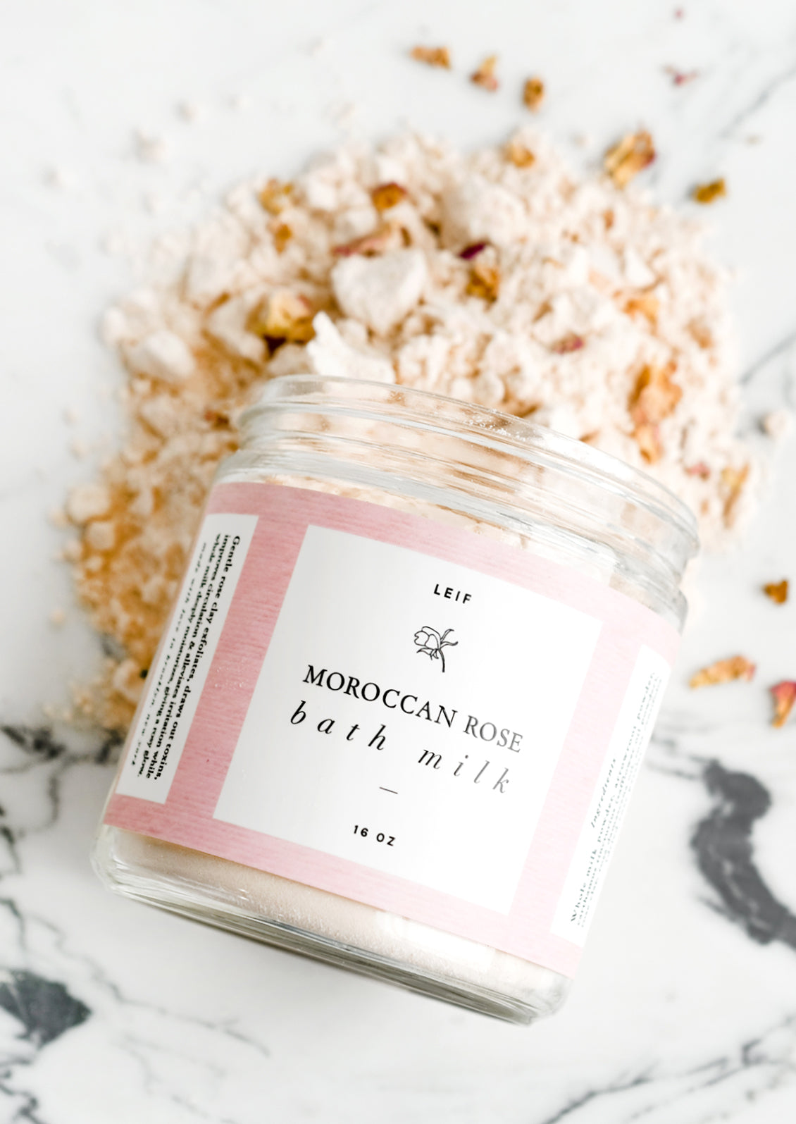 A rose scented milk bath powder in glass jar.