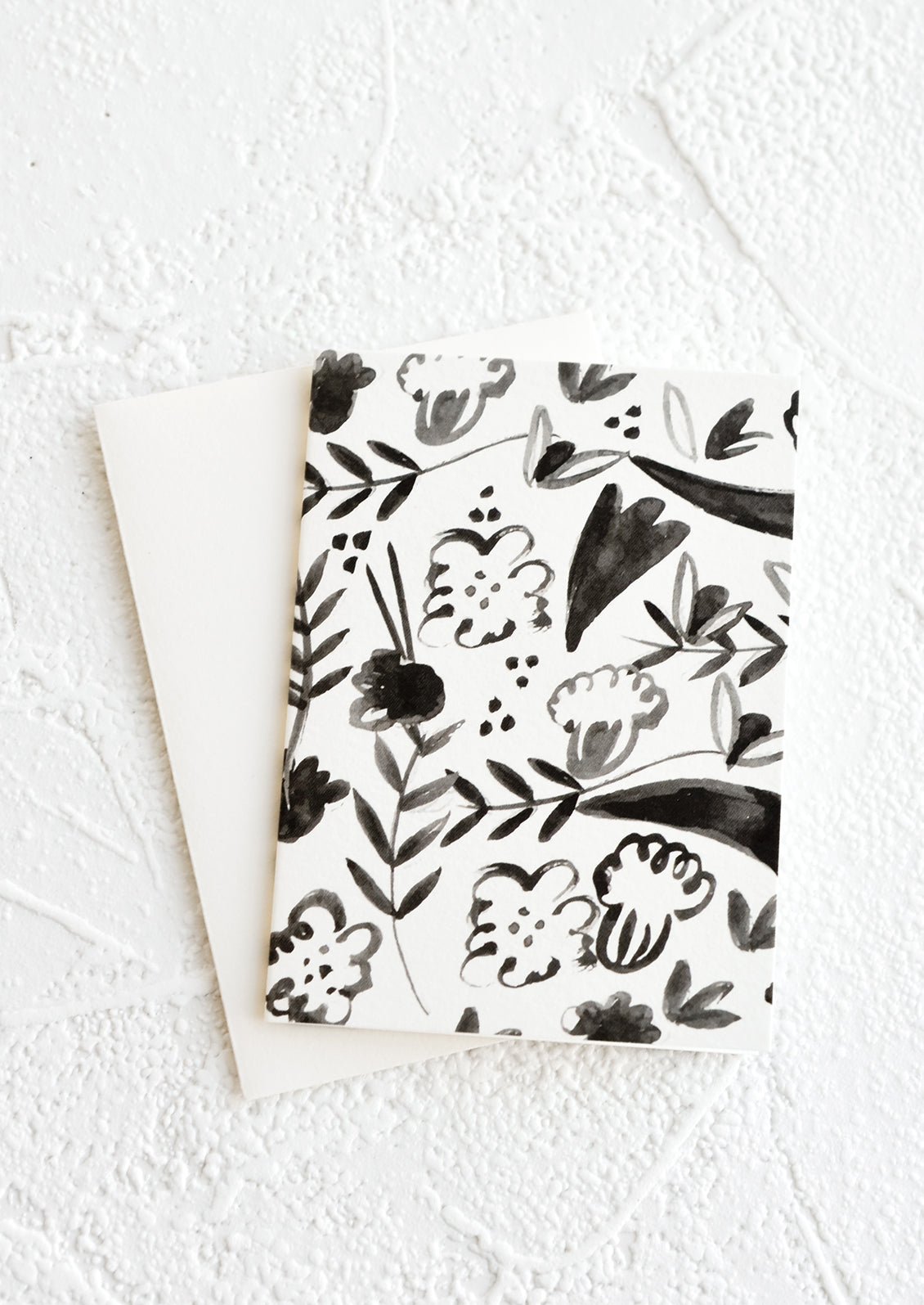 A gift enclosure greeting card with a black and white floral print.