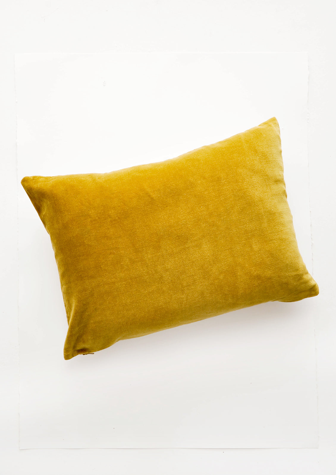 A lumbar velvet throw pillow in chartreuse.