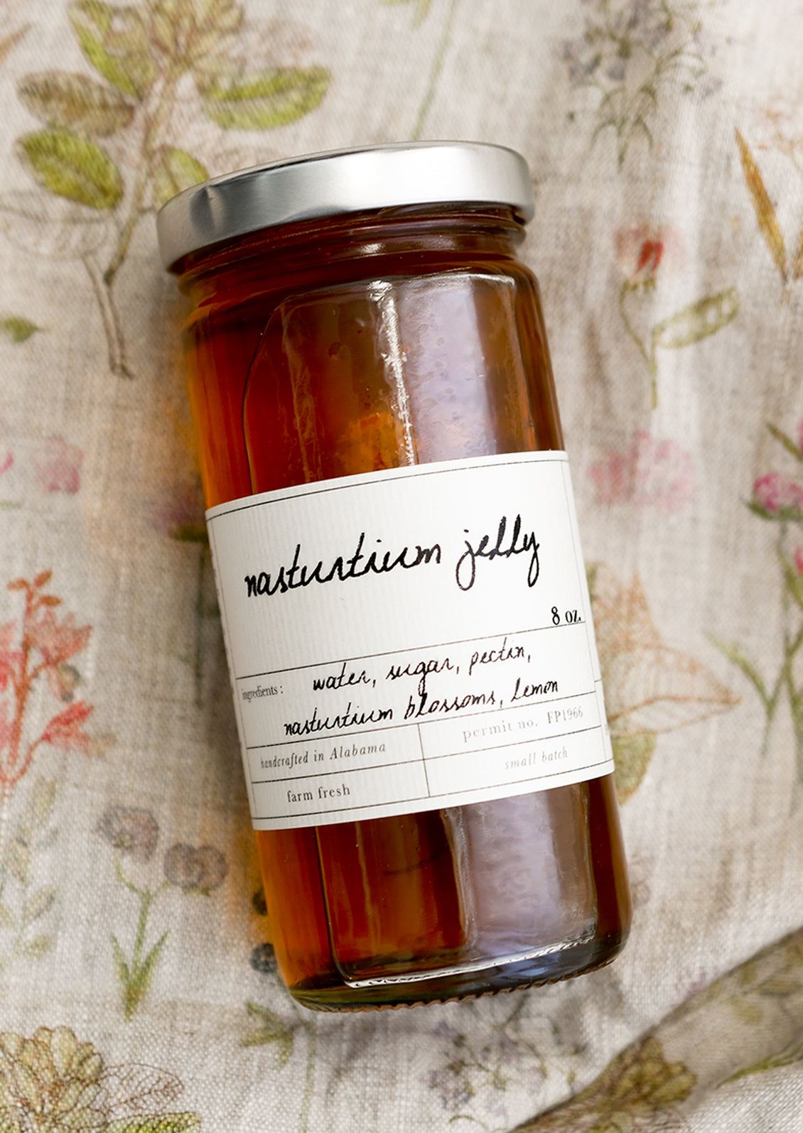 A glass jar of nasturtium jelly.