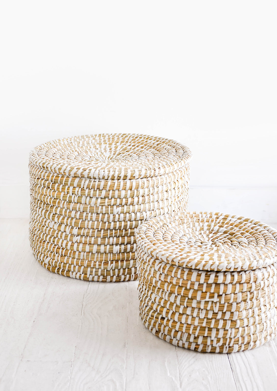 Small and large sizes of round, lidded seagrass baskets