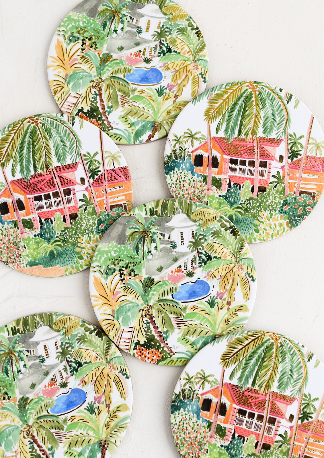 A set of six printed round coasters in tropical oasis print.