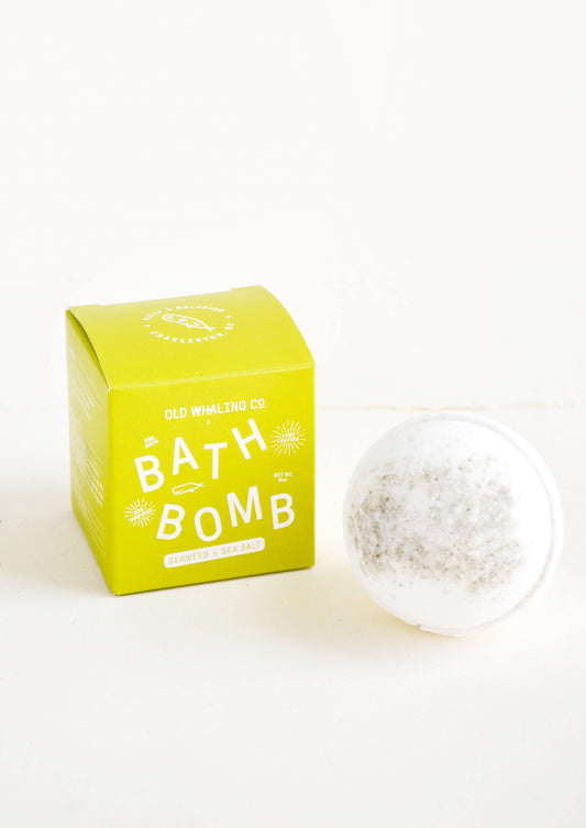 White colored, round bath bomb with green box packaging