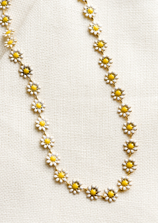 A necklace with allover yellow and white enamel flowers.