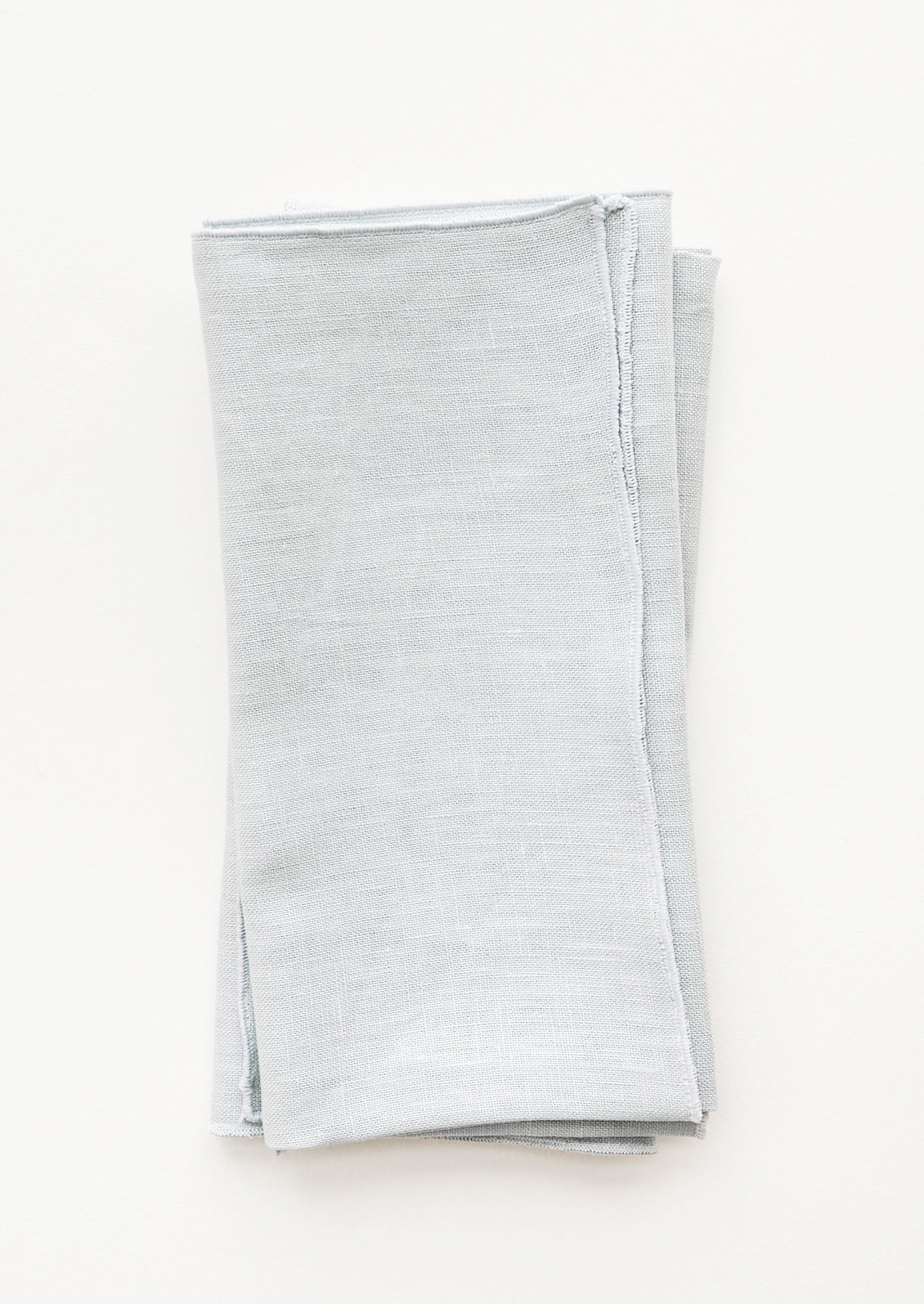 Pair of folded Linen Napkins in Misty Blue.