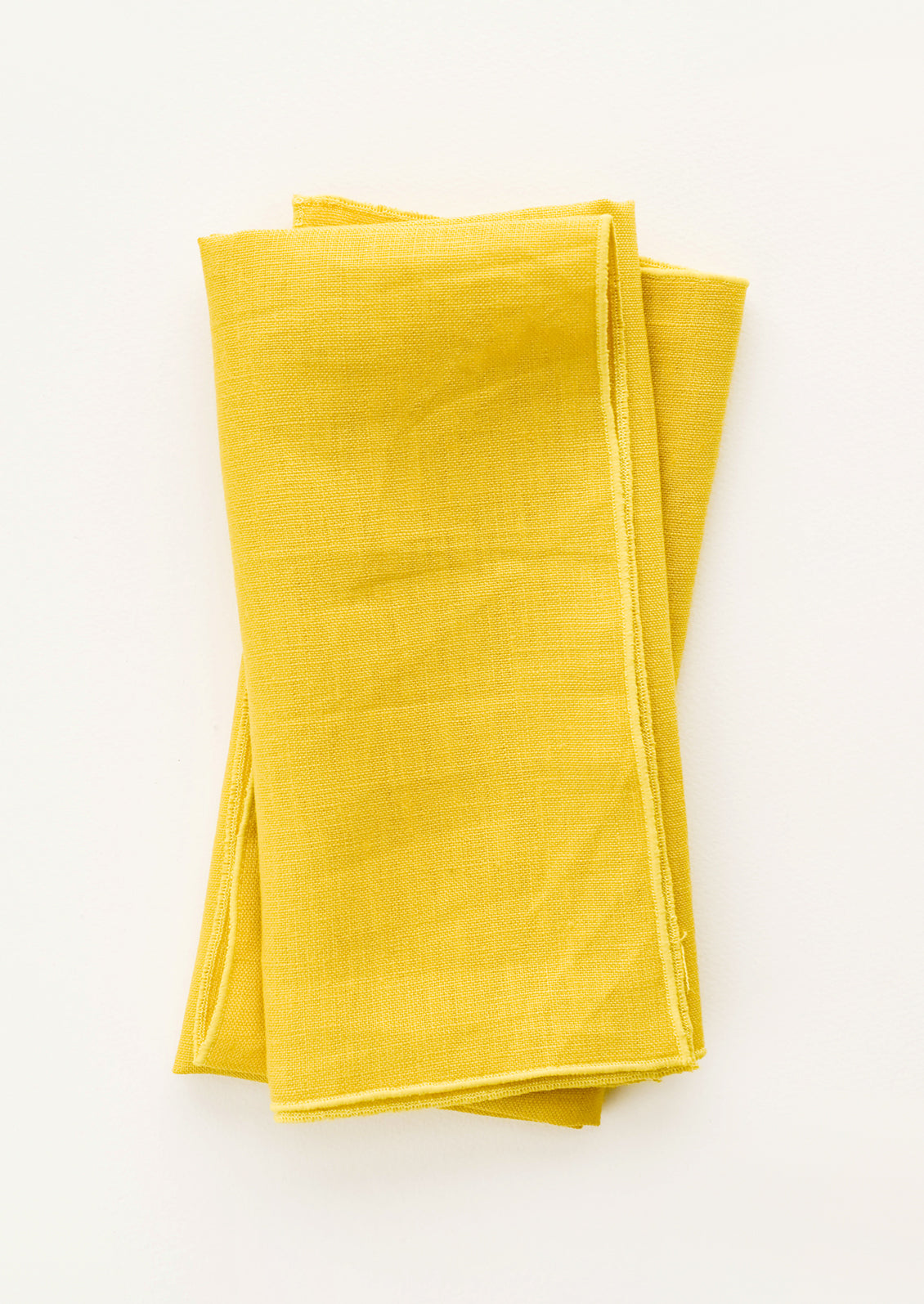 Pair of folded Linen Napkins in Yellow.