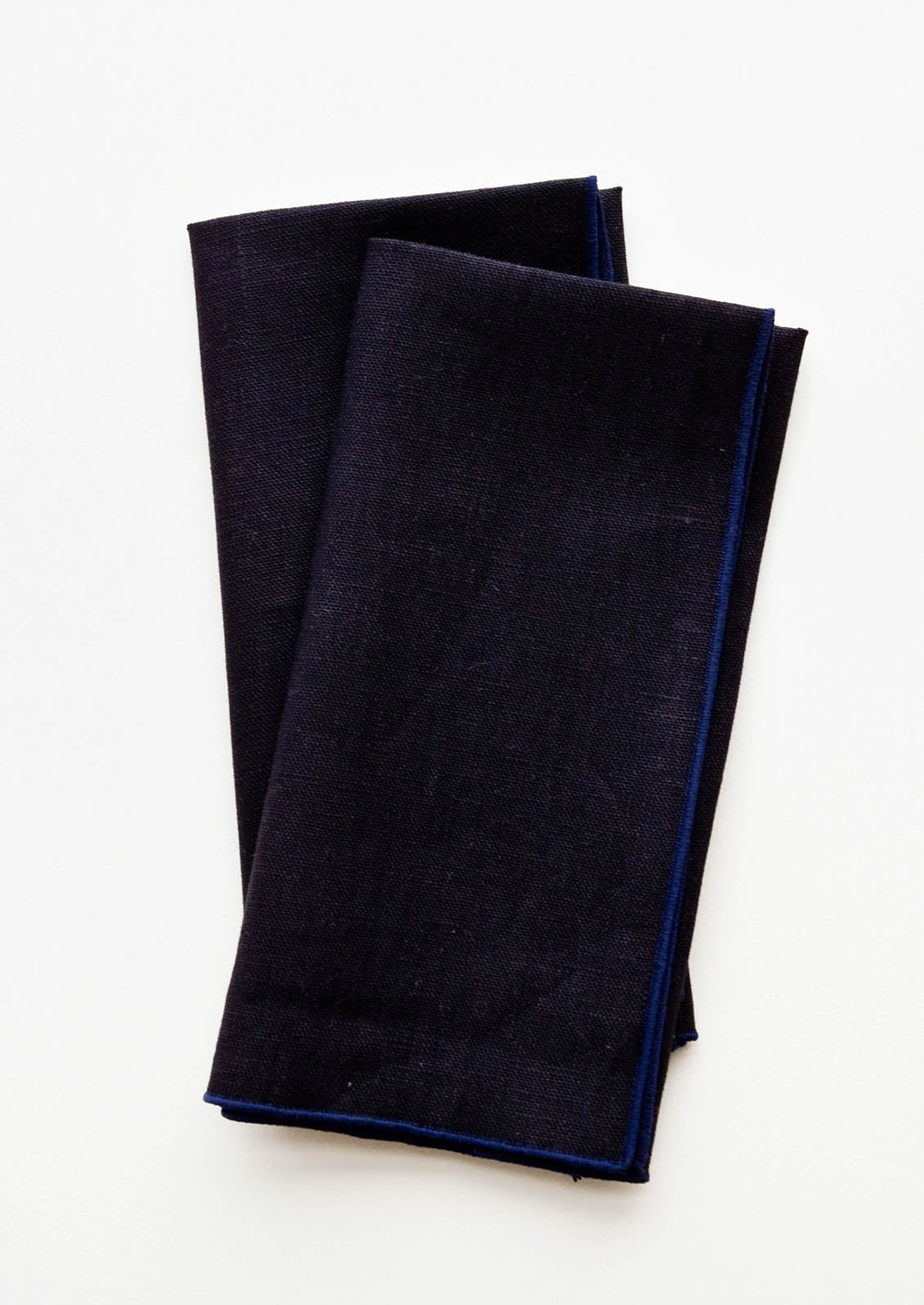 Pair of folded Linen Napkins in Navy Blue.