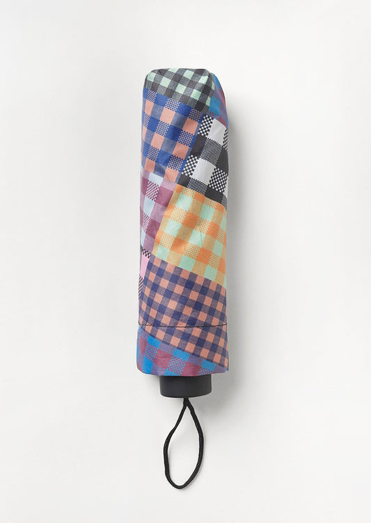 A nylon umbrella in checkered patchwork print.