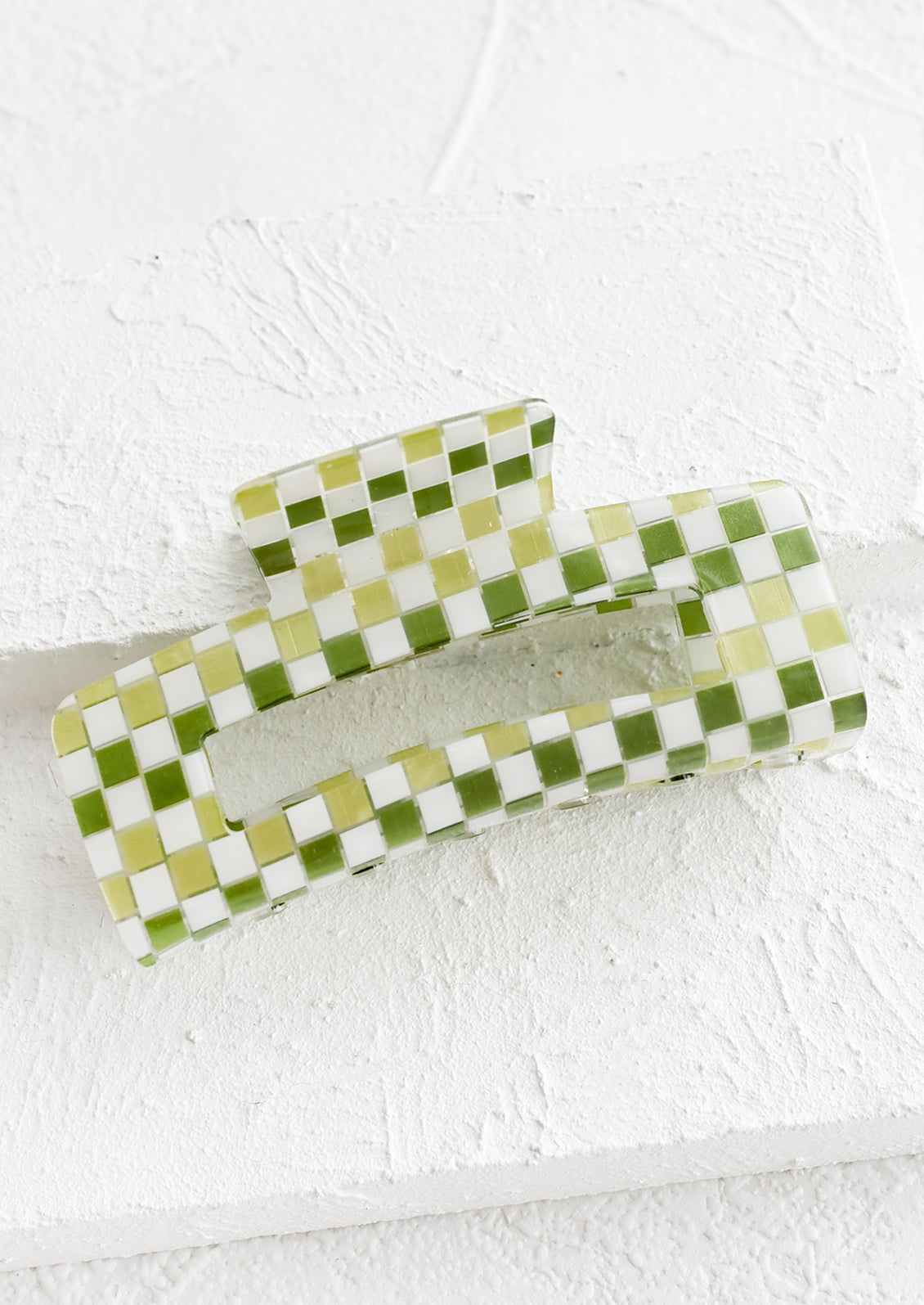 A rectangular acrylic hair clip in green check.