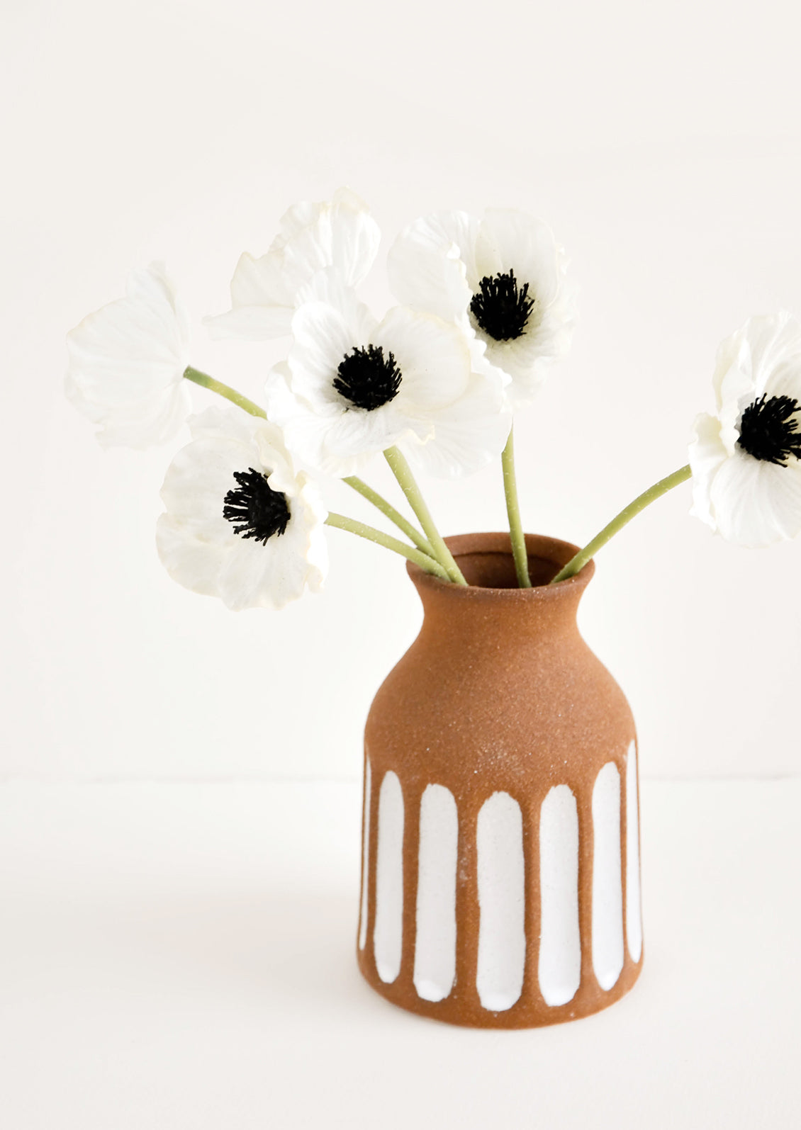 Brown Unglazed Ceramic Vase with Contrasting Vertical Stripe Detailing in White, displaying anemone flowers.