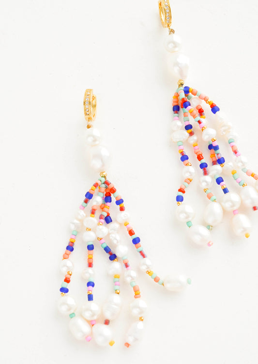 Earrings with multiple, heavily beaded dangling strands of large pearls mixed with small colorful beads