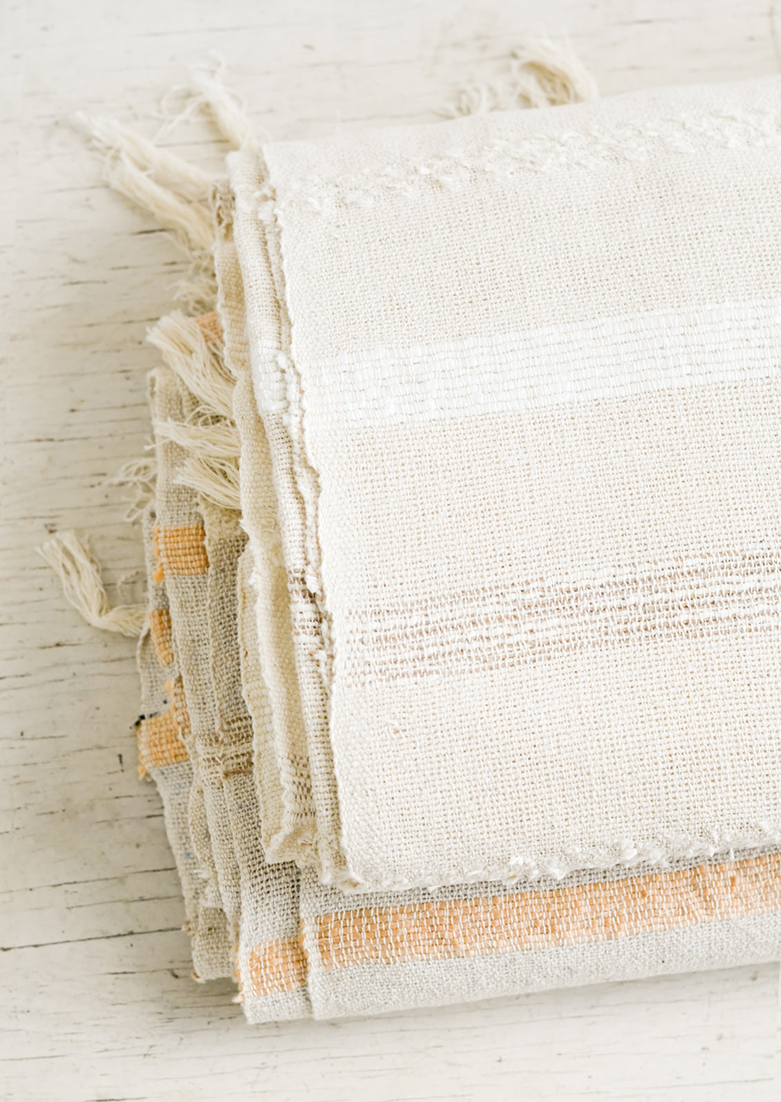 Folded gauze cotton blankets on a table.