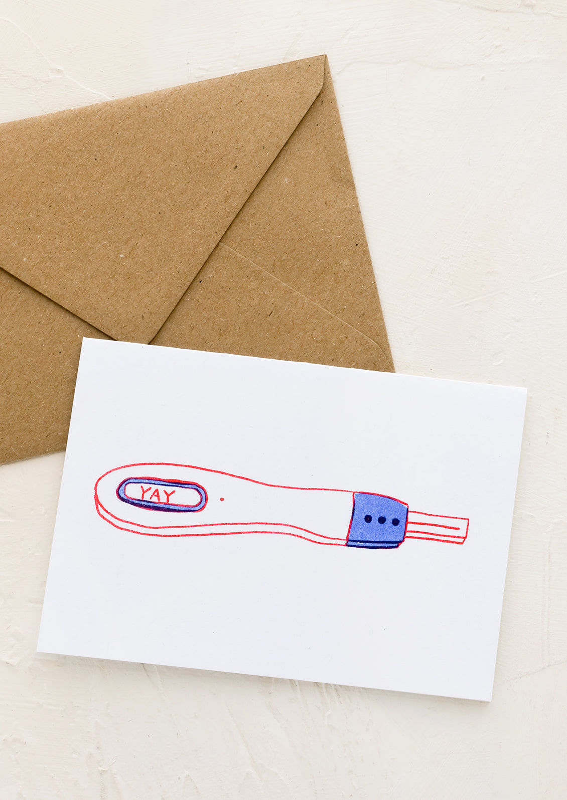 A greeting card with illustration of pregnancy test with window reading "YAY".