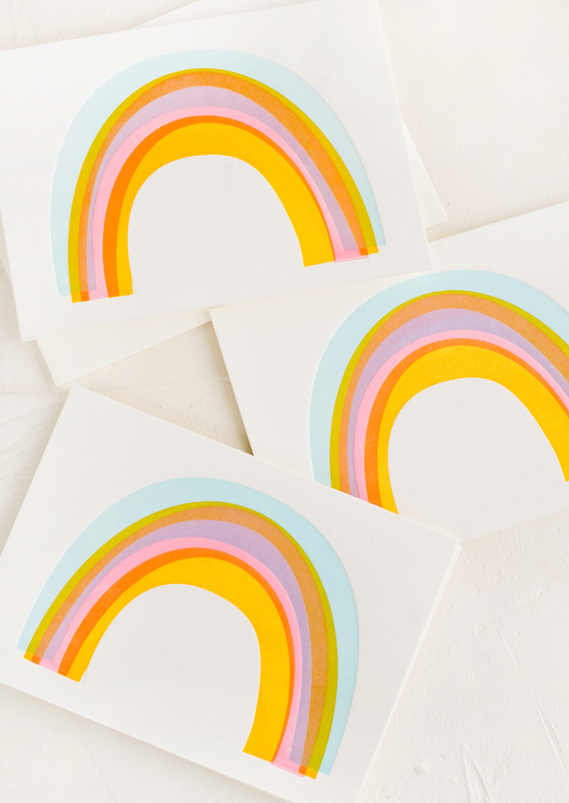 Three identical greeting cards with rainbows on front.