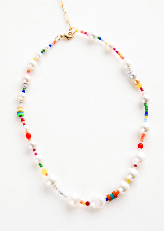 Beaded necklace with a mix of chunky freshwater pearls and rainbow-hued seed beads